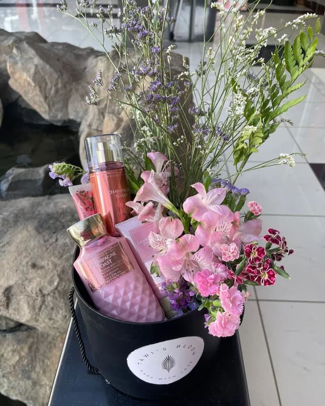 hand holding peach flower bouquet